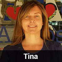 A person with long light brown hair wearing a dark shirt stands in front of a glass door featuring a red heart and blue text. The name "Tina," the local veterinarian, is displayed in a black bar at the bottom of the image.